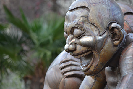 brown laughing statue of man closeup photography thumbnail
