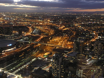 aerial photography of cityscape at night under cloud formation thumbnail