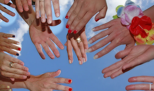 people gather around reaching their hands thumbnail