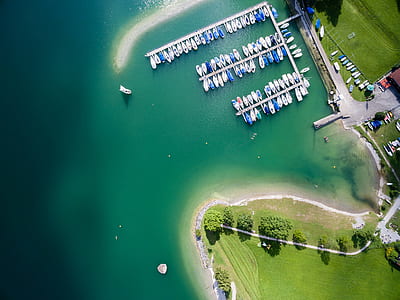 aerial view of dock surrounded by teal and blue body of water during daytime thumbnail