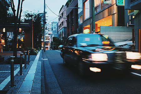 time lapse photography of black car driving at road thumbnail