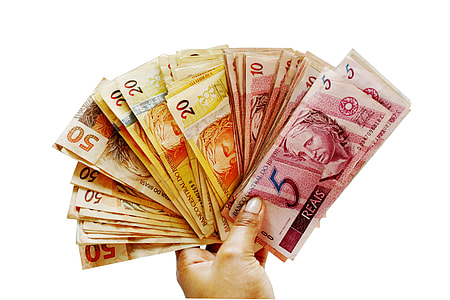 person holding assorted banknote lot thumbnail