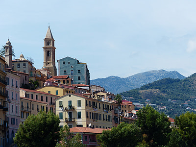 buildings near green mountain range thumbnail