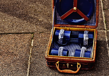 blue picnic set in wicker case on concrete floor thumbnail
