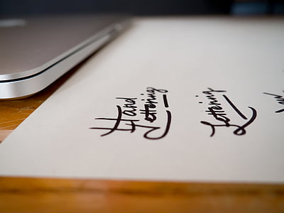 MacBook beside paper thumbnail