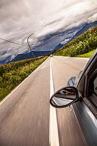 vehicle on road under white clouds thumbnail