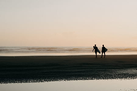 two person walking on beach with surfboard thumbnail