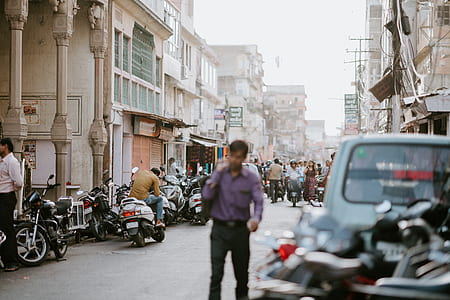 man wearing dress shirt and pants standing on road thumbnail