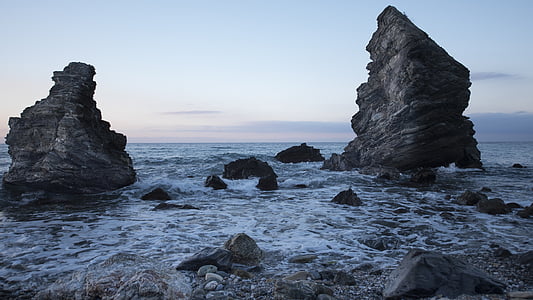 rock formation on body of water thumbnail