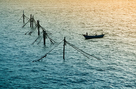 Silhouette Of Boat Sailing On Large Body Of Water thumbnail