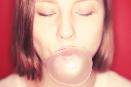 selective focus photography of woman blowing gum thumbnail