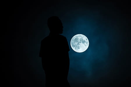 silhouette of person and full moon thumbnail
