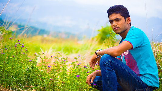 man sitting near green leafed plant thumbnail