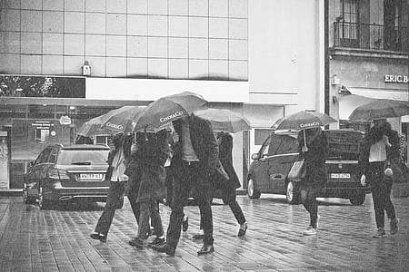 grayscale photography of people walking on concrete pavement thumbnail