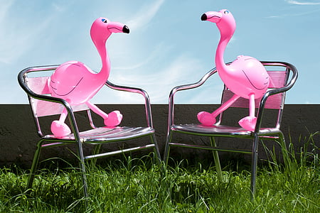 two pink flamingo balloons on top of chairs thumbnail