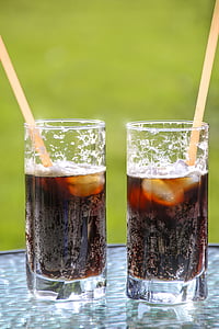 two clear drinking glasses filled with black liquid thumbnail
