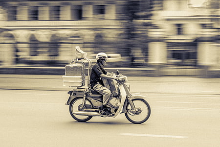 man riding on motor scooter thumbnail