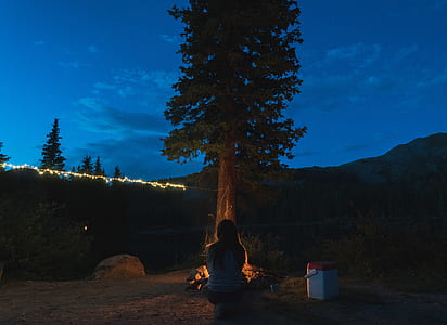 woman sitting beside fire thumbnail