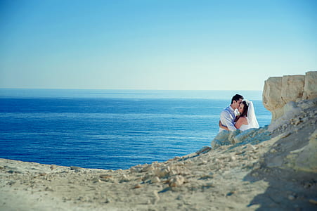 couple on shore under blue sky during daytime thumbnail