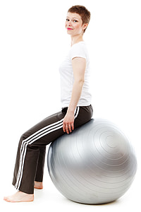 woman in white shirt and black sweat pants sitting on gray stability ball thumbnail