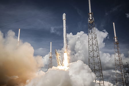 white rocket launching upward at daytime thumbnail