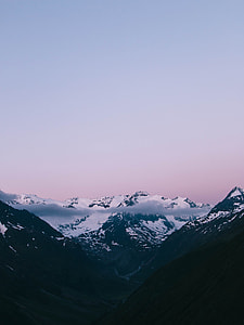 snow-covered mountain under white sky photography thumbnail