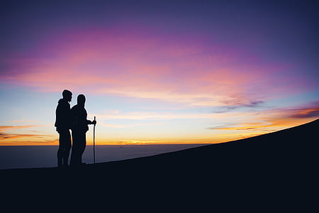silhouette of man and woman on mountain thumbnail