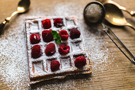 Breakfast waffles with fresh raspberries and powdered sugar thumbnail
