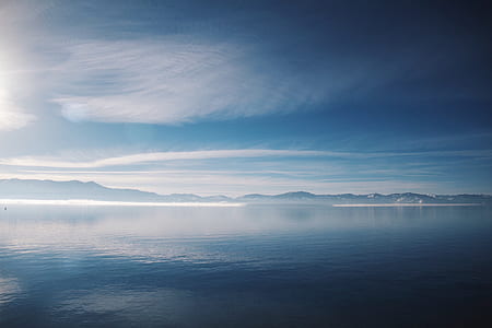 ocean with mountain range view during daytime thumbnail