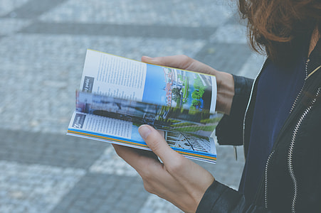 woman reading book on street thumbnail