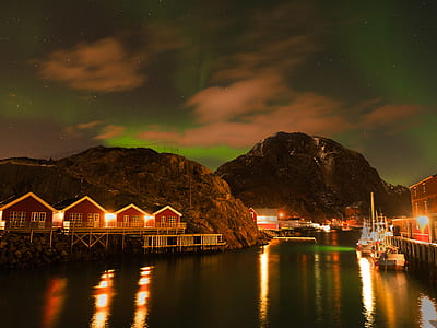 houses on the foot of the hills near body of water thumbnail