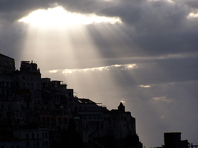 white concrete structure under white clouds during daytime thumbnail