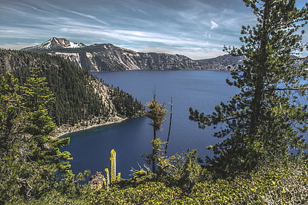 body of water beside mountain thumbnail