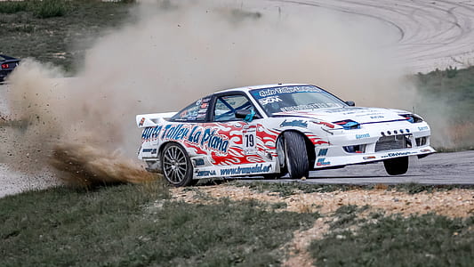 racing car drifting near road gutter thumbnail