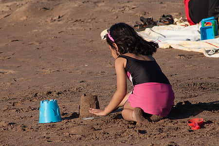 girl building sand castle thumbnail
