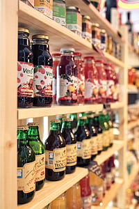 assorted-color glass bottles on shelf thumbnail