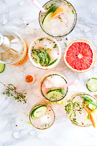 flat lay photography of fruits and drinking glasses filled with juices thumbnail
