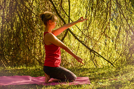woman doing yoga beside plants thumbnail