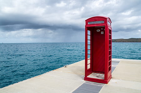 red phone booth on beach dock thumbnail