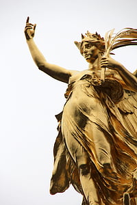 gold statue of a woman with her finger pointing upward thumbnail