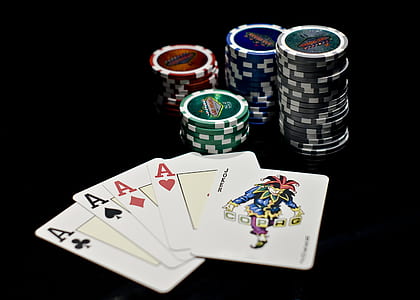 four Ace playing cards next to poker chips thumbnail