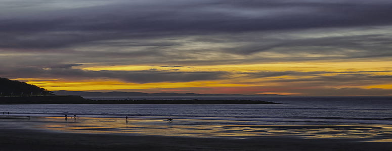 beach under cloudy sky thumbnail