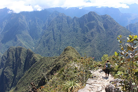 man standing on top of mountain cliff thumbnail