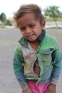 selective focus photography of boy wearing green long-sleeved shirt thumbnail