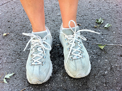 person's feet wearing blue-and-white running shoes thumbnail