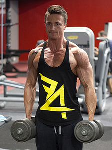man carrying pair of gray fixed weight dumbbells thumbnail