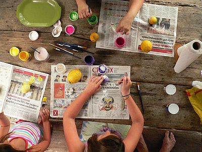 girls painting easter eggs on the table thumbnail
