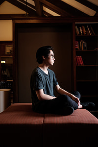 man sitting on brown padded cushion thumbnail