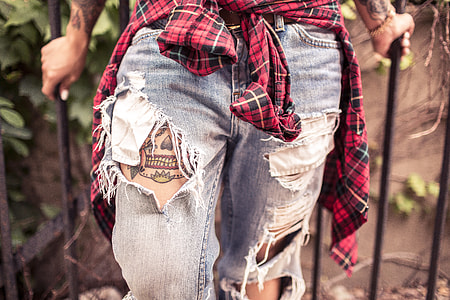 person wearing blue distressed jeans thumbnail