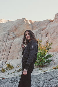 woman standing near brown rocks thumbnail
